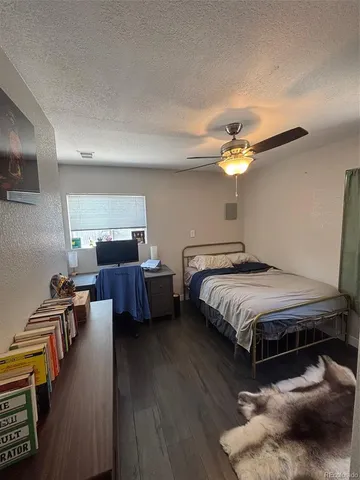 a spacious bedroom with a bed and a chandelier