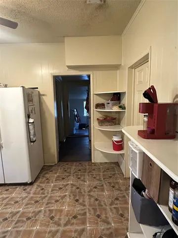 a kitchen with refrigerator and window
