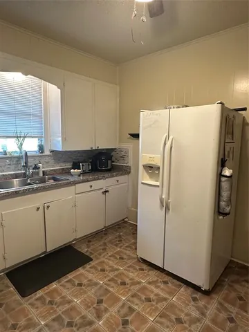 a white refrigerator freezer sitting inside of a kitchen