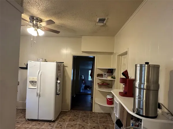 a kitchen with stainless steel appliances a refrigerator and a stove