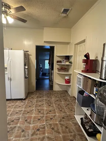 a room with furniture and a refrigerator