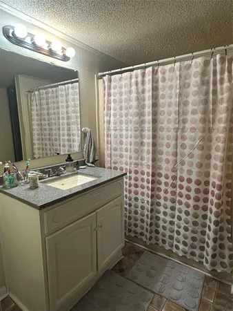 a bathroom with a sink and a shower