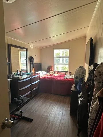 a room with furniture wooden floor and a window