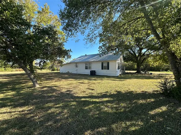 a front view of house with yard and swimming pool