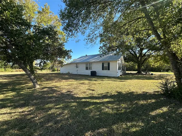 a front view of house with yard and swimming pool