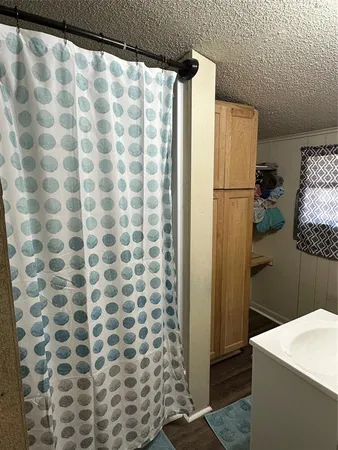 a bathroom with a shower curtain and a sink