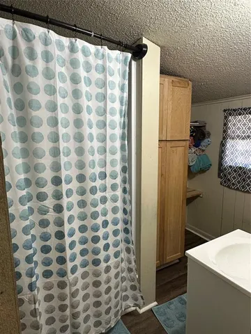 a bathroom with a shower curtain and a sink