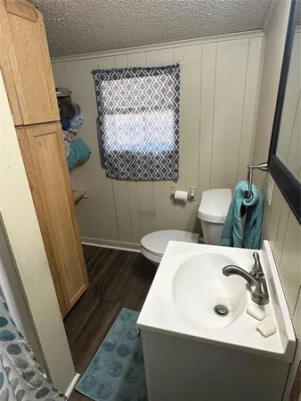 a bathroom with a sink and mirror with bathtub