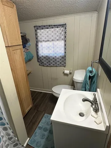 a bathroom with a sink and mirror with bathtub