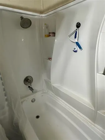 a bathroom with a shower and a bathtub