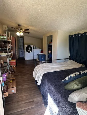 a bed sitting in a bedroom and dresser with wooden floor