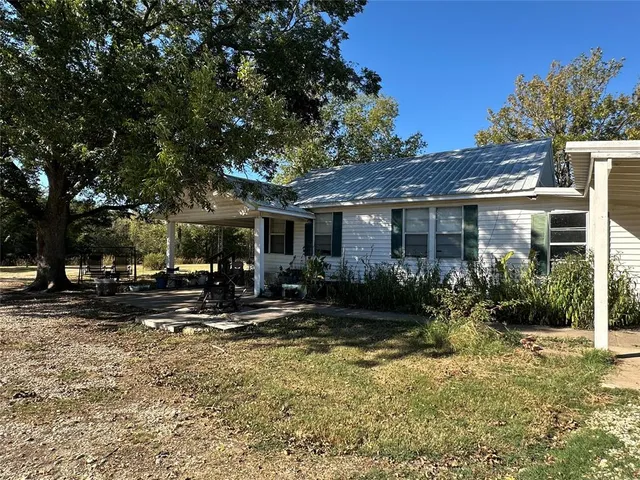 a view of a house with backyard porch and sitting area