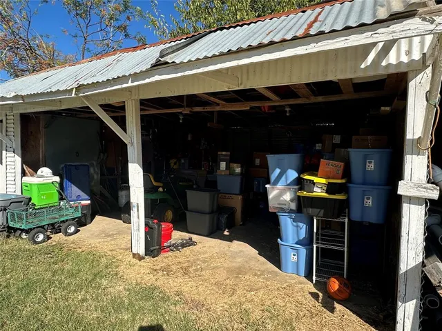 a view of a house with a patio and a yard