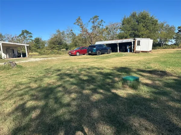 a view of a swimming pool with a yard and trees