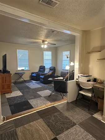 a living room with furniture a rug and a chandelier
