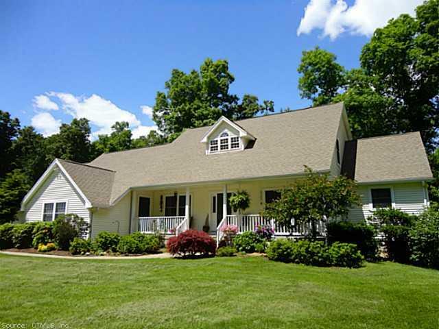 a front view of a house with a garden and plants