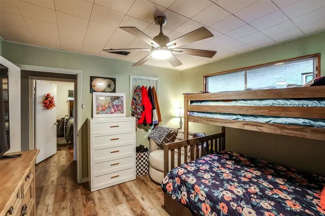 a view of a bedroom with closet and a ceiling fan