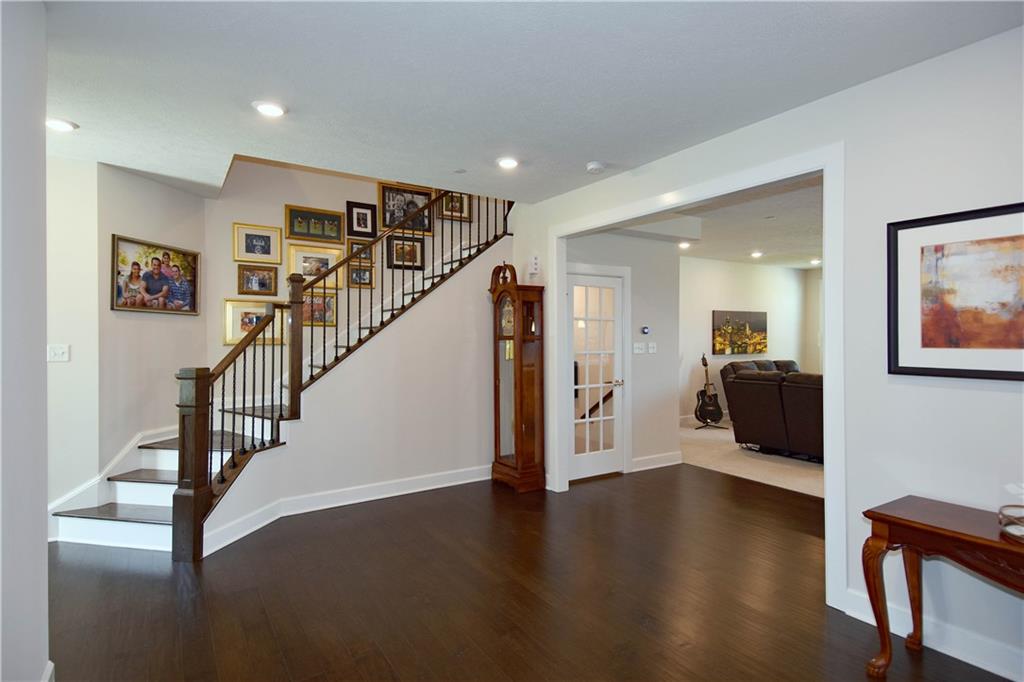 4103 Spruce Road Gibsonia, PA 15044 - Photo 4 of 25 a view of a hallway with wooden floor and windows