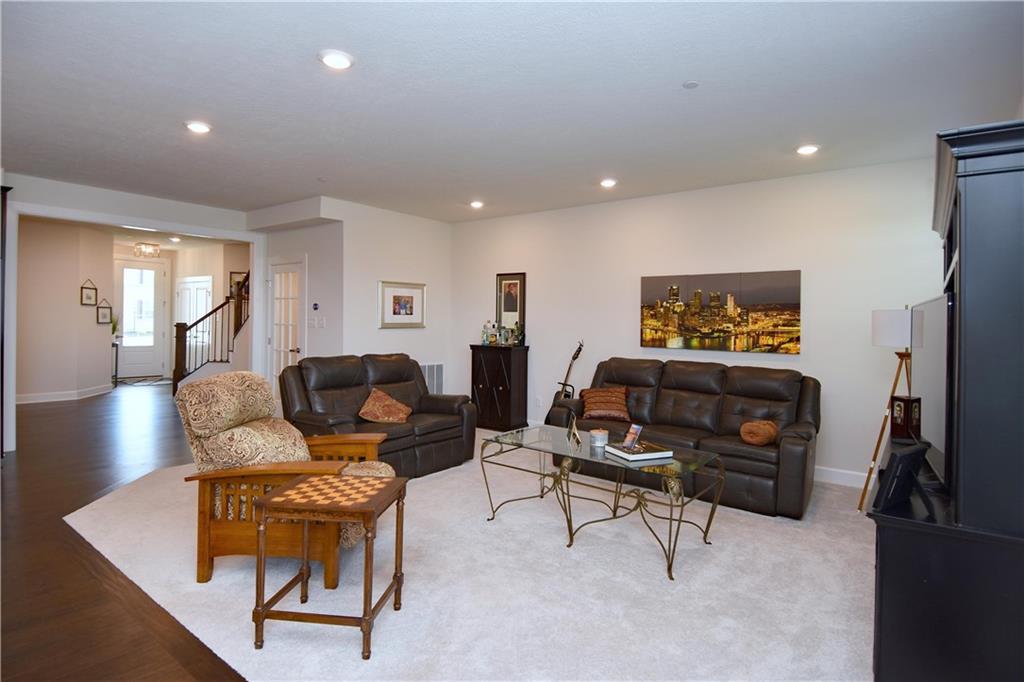 4103 Spruce Road Gibsonia, PA 15044 - Photo 9 of 25 a living room with furniture and a flat screen tv with kitchen view