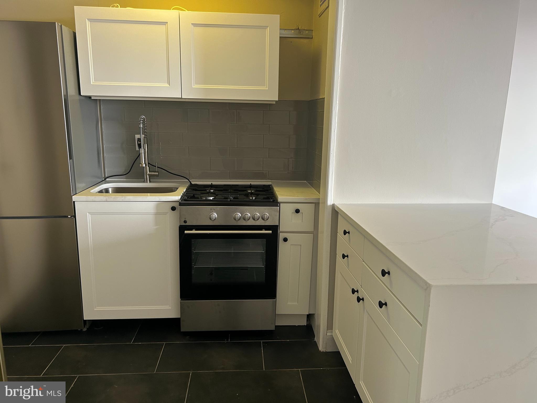 1810-18 Rittenhouse Square, Unit 1609 Philadelphia, PA 19103 - Photo 3 of 14 a stove top oven sitting inside of a kitchen