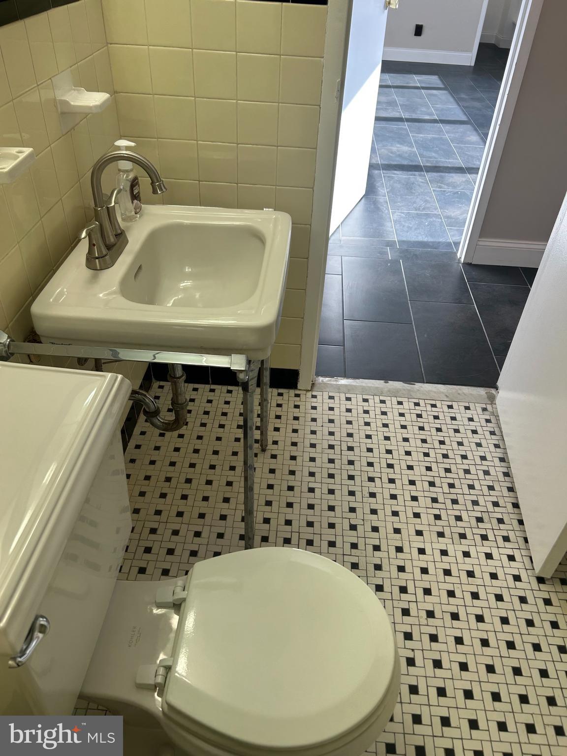 1810-18 Rittenhouse Square, Unit 1609 Philadelphia, PA 19103 - Photo 10 of 14 a bathroom with a sink a toilet and a mirror