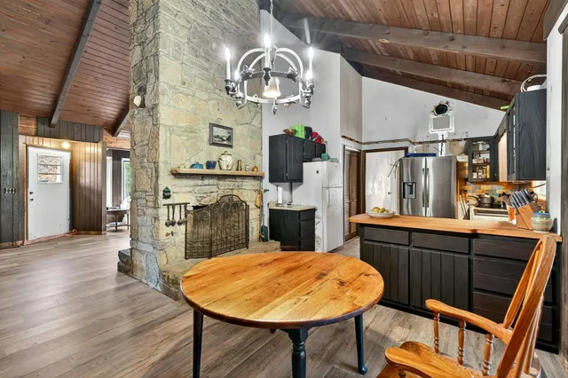 a kitchen with stainless steel appliances wooden floors and wooden cabinets