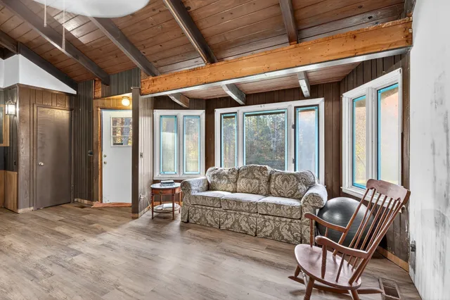 a view of a livingroom with furniture and an entryway