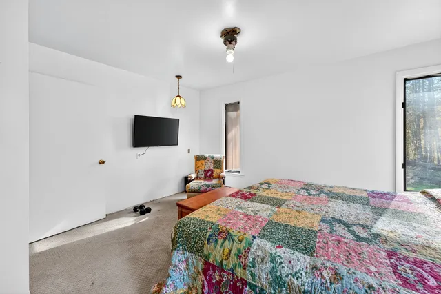 a bedroom with a bed and a mirror