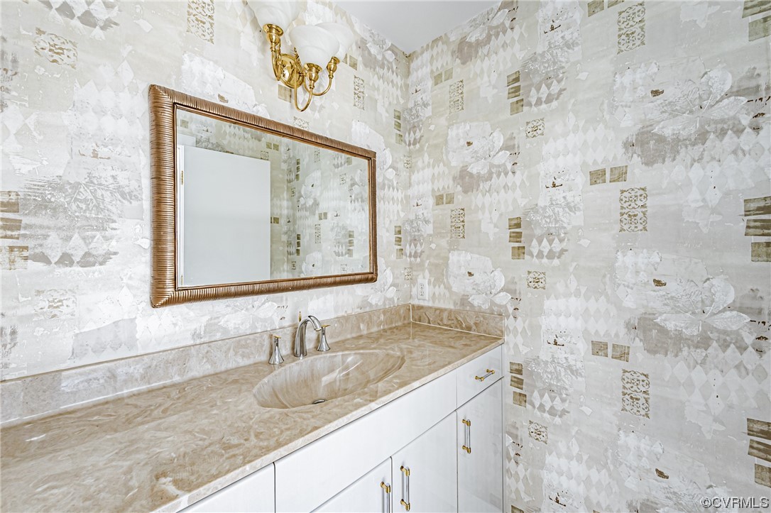13510 Stonegate Road Midlothian, VA 23113 - Photo 38 of 50 a bathroom with a granite countertop sink and a mirror
