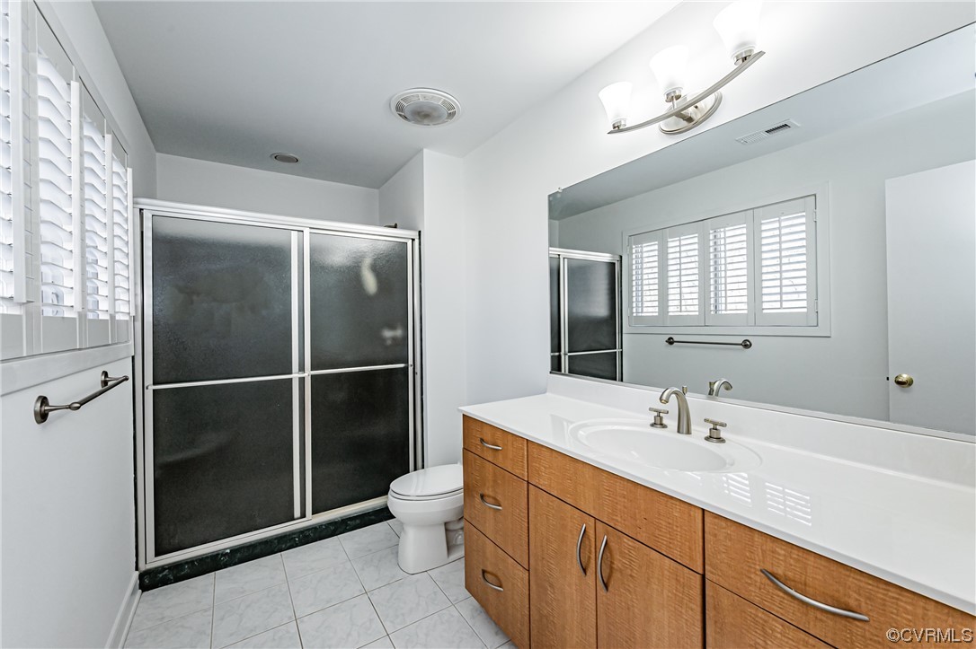 13510 Stonegate Road Midlothian, VA 23113 - Photo 40 of 50 a bathroom with a double vanity sink mirror and toilet