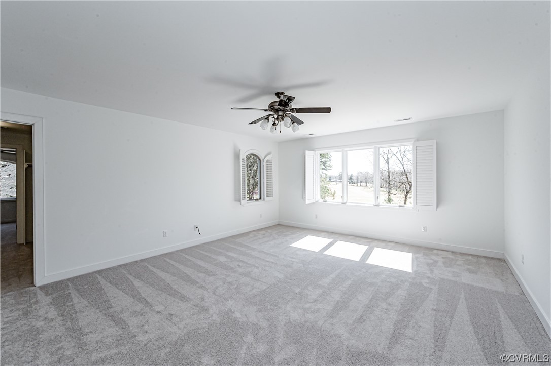 13510 Stonegate Road Midlothian, VA 23113 - Photo 42 of 50 an empty room with windows and chandelier fan