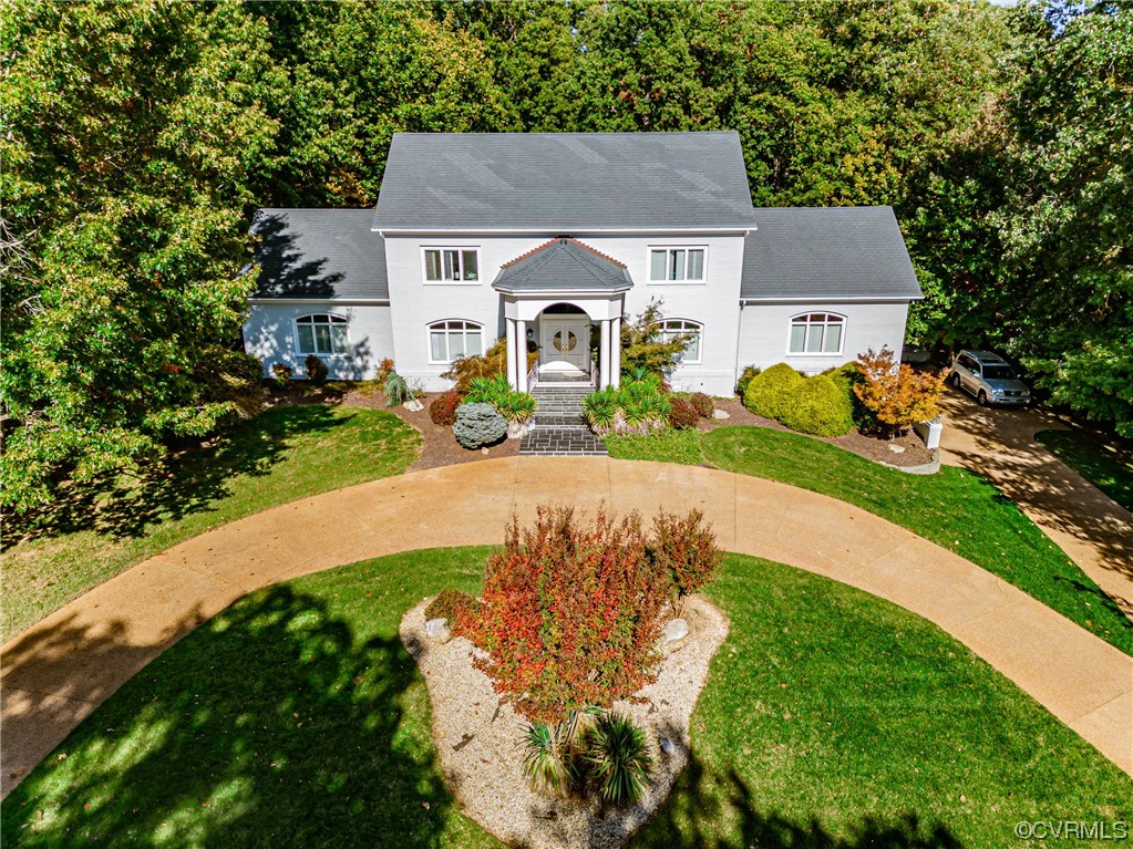 13510 Stonegate Road Midlothian, VA 23113 - Photo 5 of 50 a front view of a house with a yard and potted plants