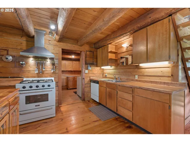 a kitchen with a table chairs and refrigerator