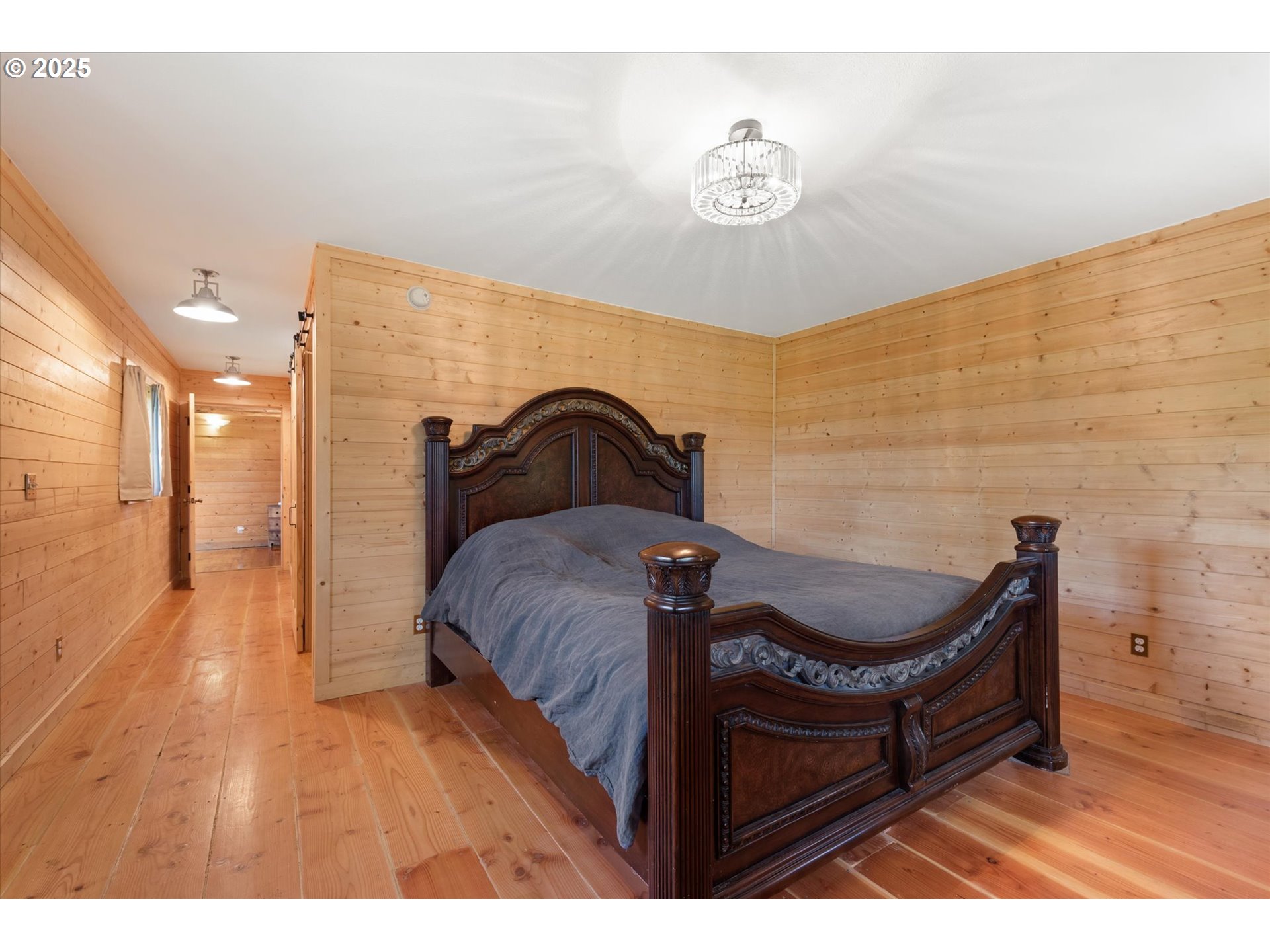 35912 Valley View Lane Halfway, OR 97834 - Photo 25 of 43 a bedroom with a bed and a chandelier