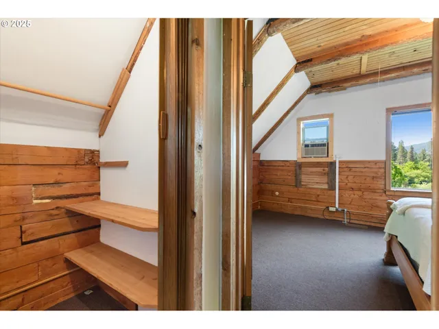 a bedroom with a bed chair and a window