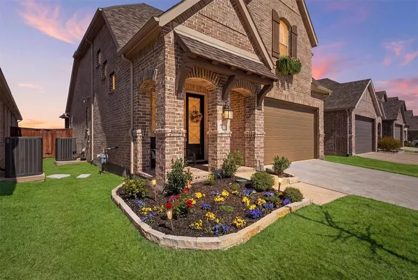 a front view of a house with garden
