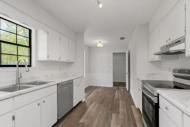 a kitchen that has a sink and a stove