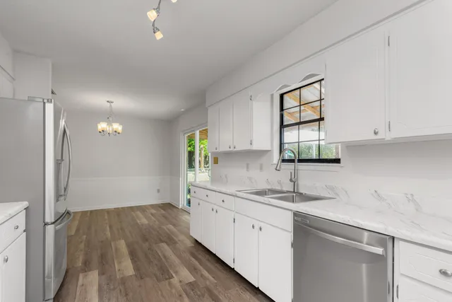 a kitchen with a sink window and cabinets