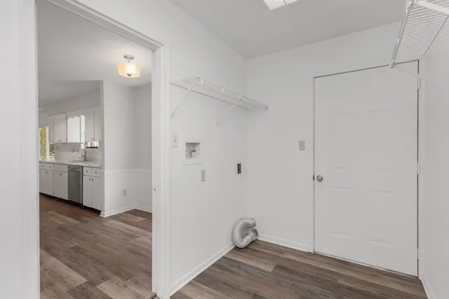 a view of a room with a wooden floor and a sink