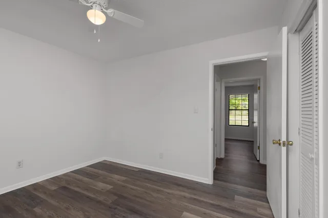 a view of a room with wooden floor and a window