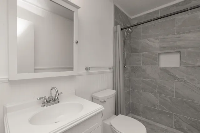 a bathroom with a sink toilet and shower