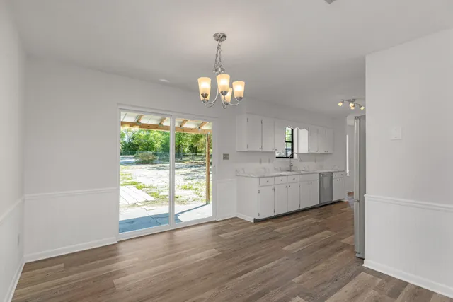 a view of a kitchen and a sink wooden floor
