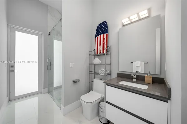 a bedroom with a bed a flat screen tv and a couch