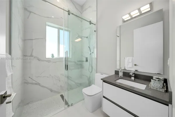 a bathroom with double sink and a mirror