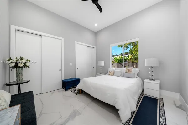 a bedroom with a bed and a window