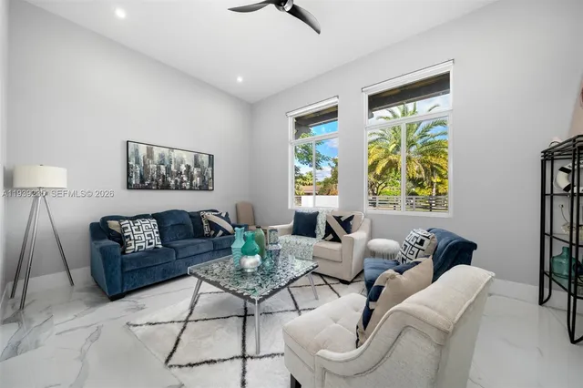 a view of a house with swimming pool and sitting area