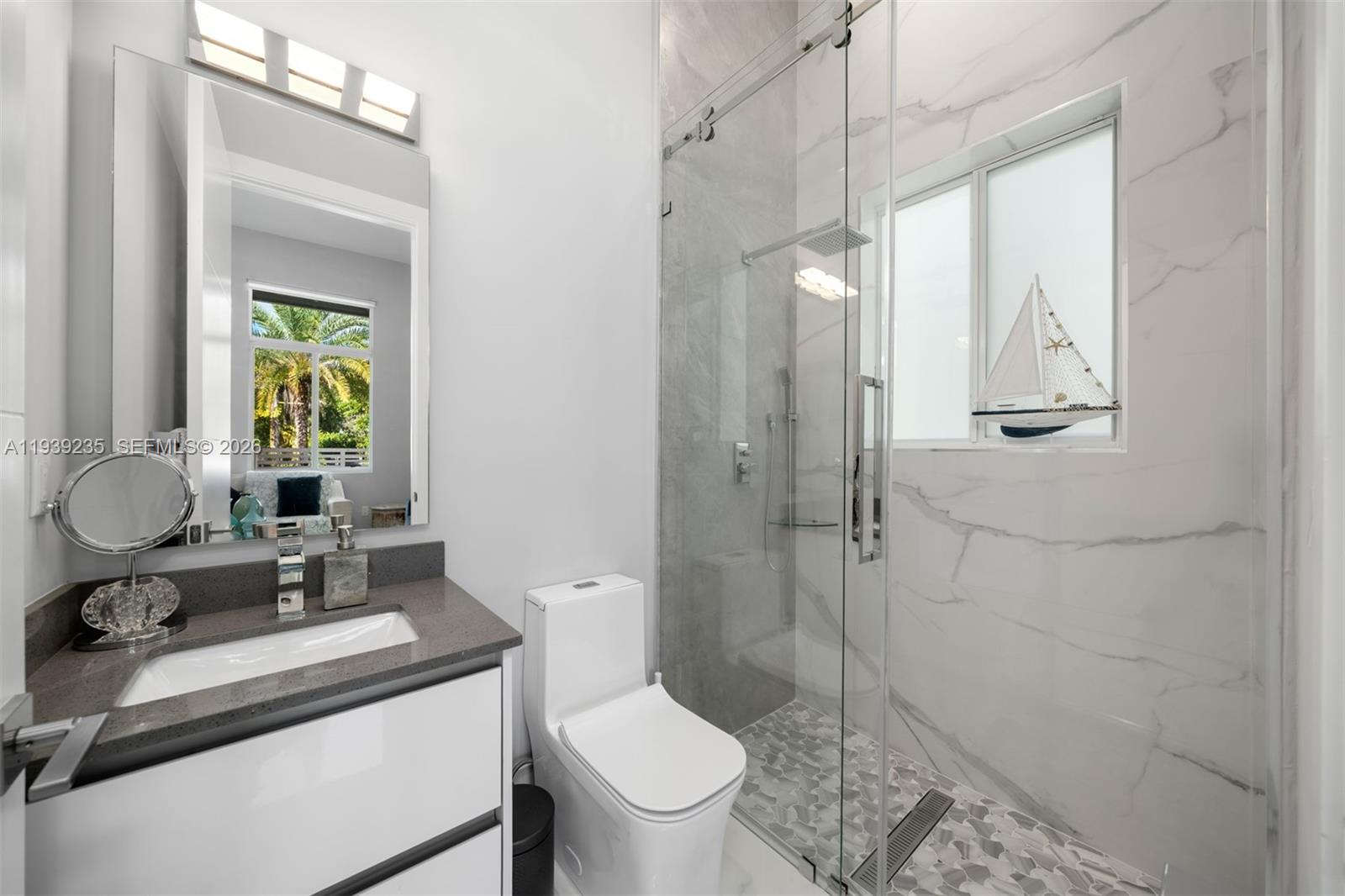 10250 Southwest 135th Street Miami, FL 33176 - Photo 24 of 35 a bathroom with a toilet a sink and glass door