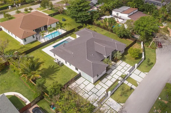 an aerial view of a house with a garden and swimming pool
