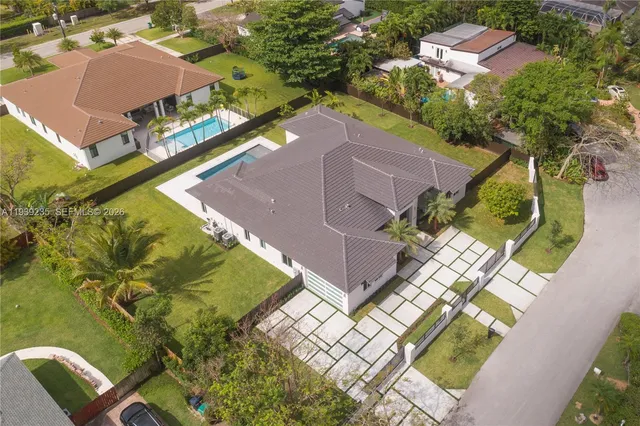 an aerial view of a house with a garden and swimming pool