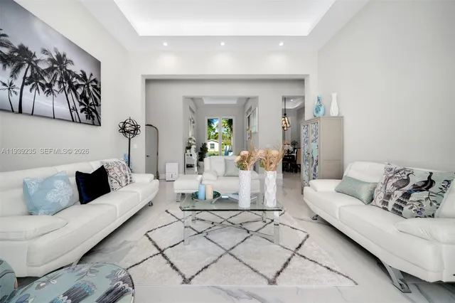 a living room with furniture and large windows